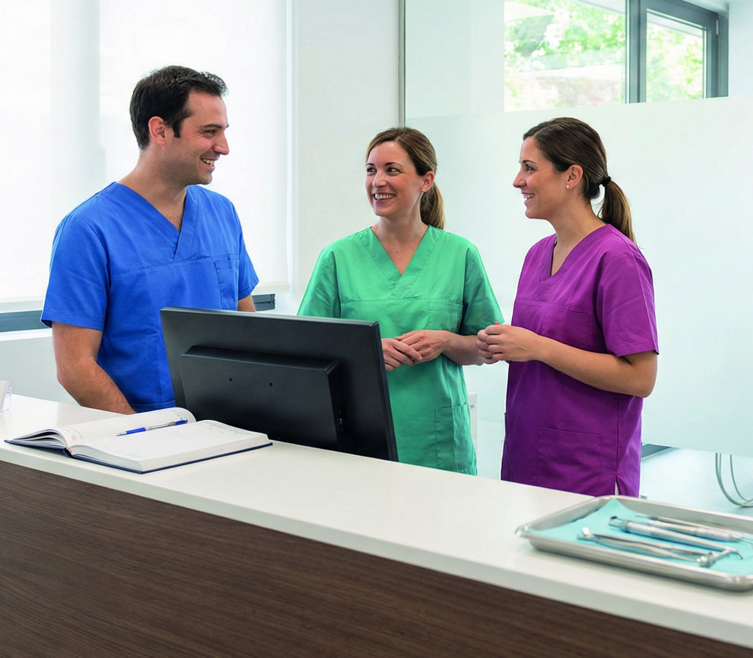 Dental office administrator helping a patient with coverage questions